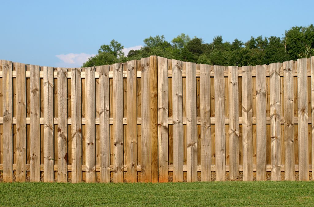 a scalloped wood fence landscape